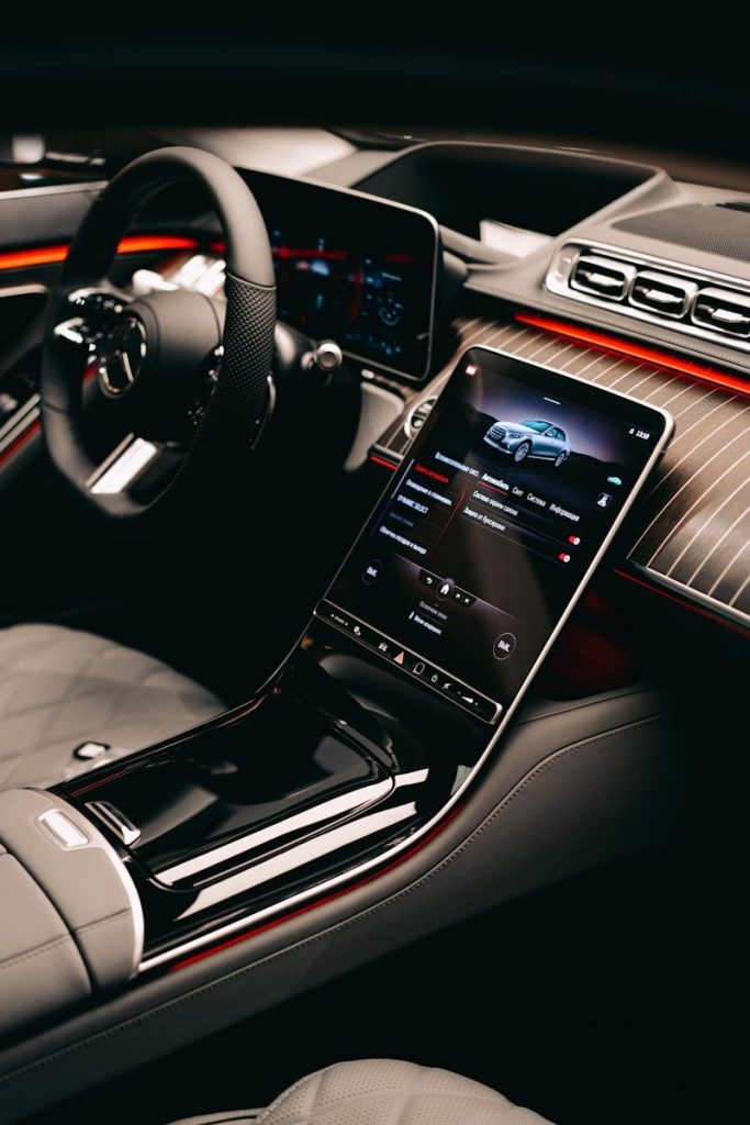 a car dashboard with a cell phone in the center