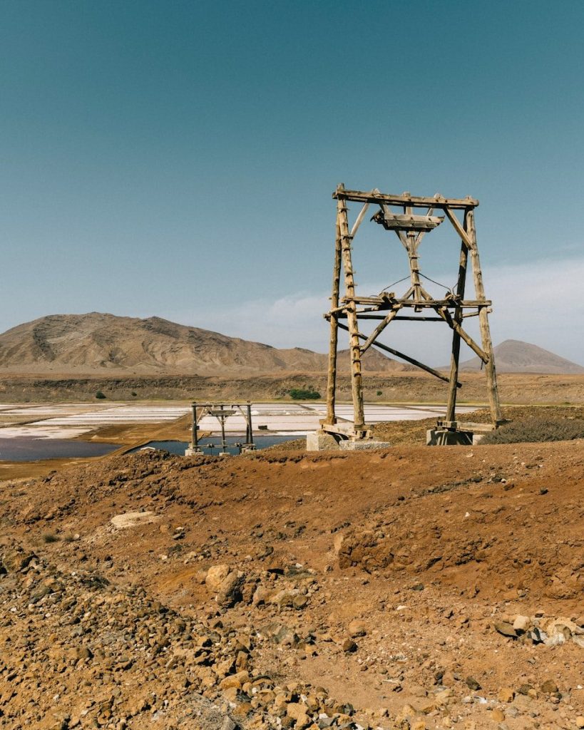 brown wooden tower near body of water during daytime