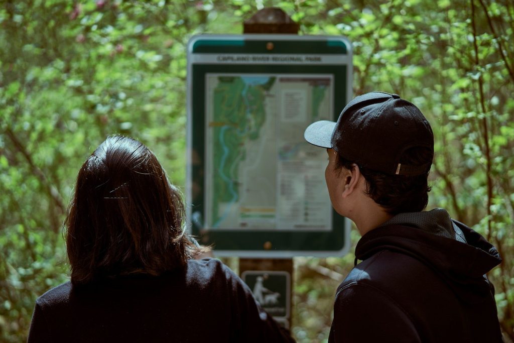 a man and woman looking at a map on a wall
