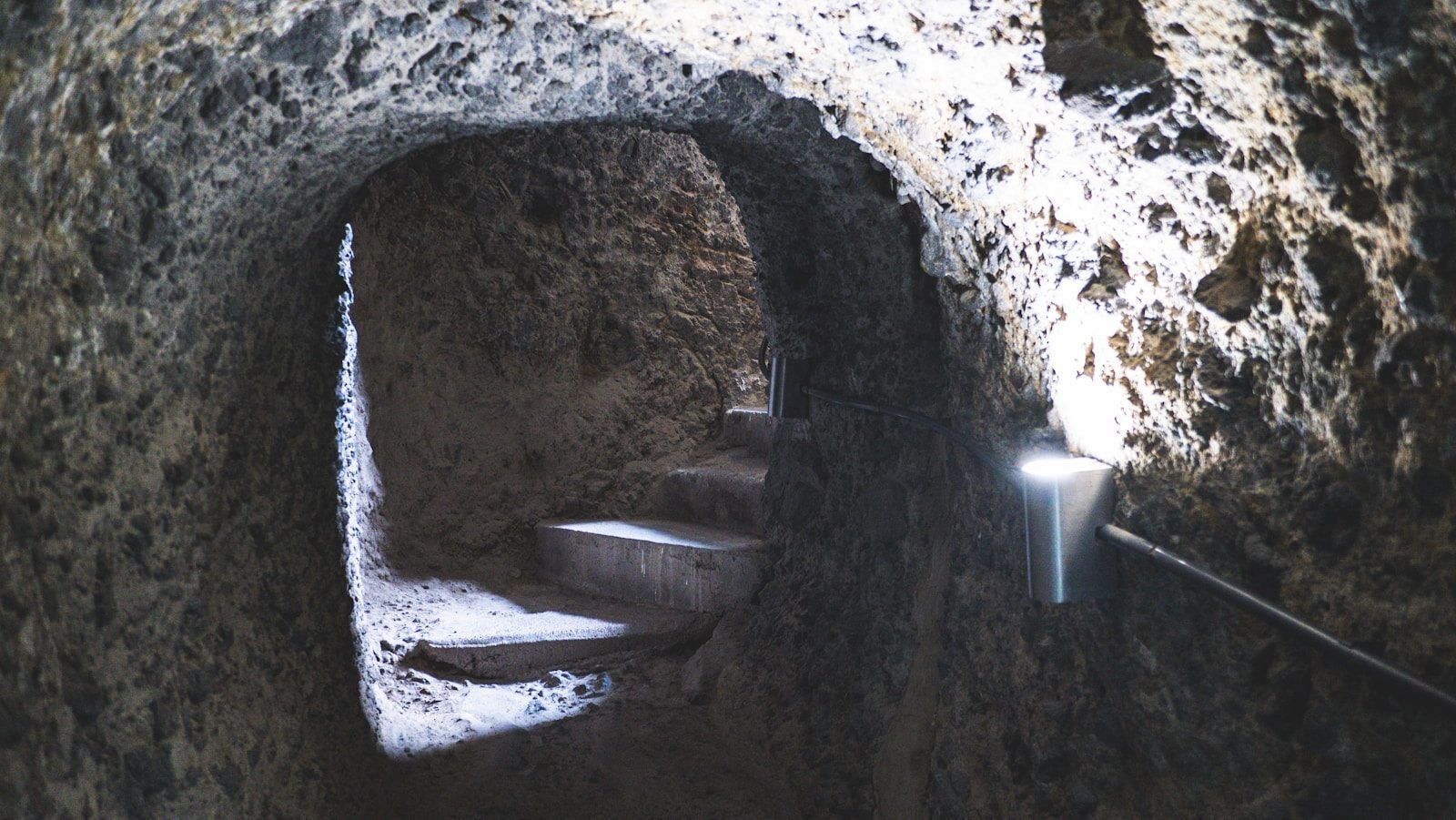 A light shines in the middle of a tunnel