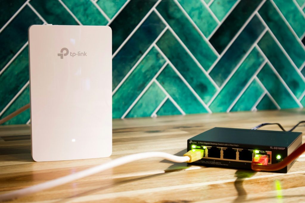 A wi-fi router and a network switch sit side-by-side.