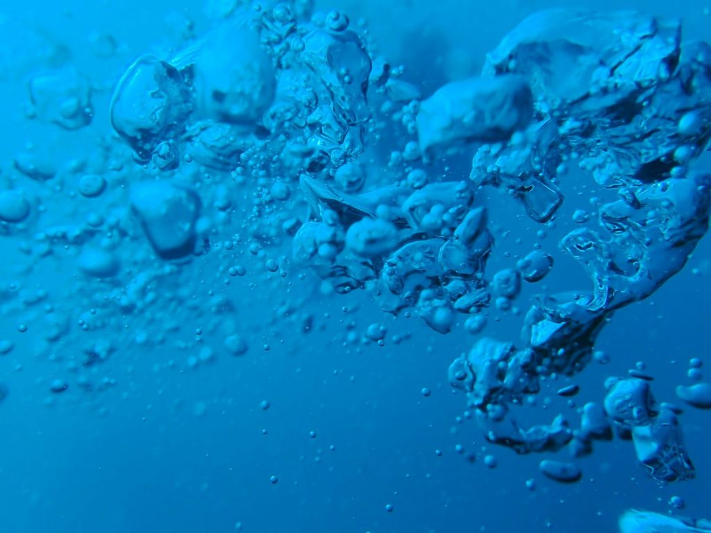 a bunch of bubbles floating in the water