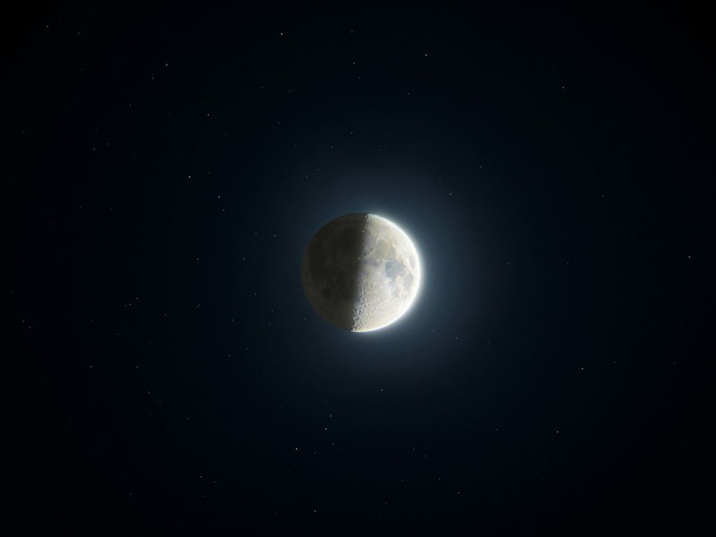 Half moon glowing in a starry night sky