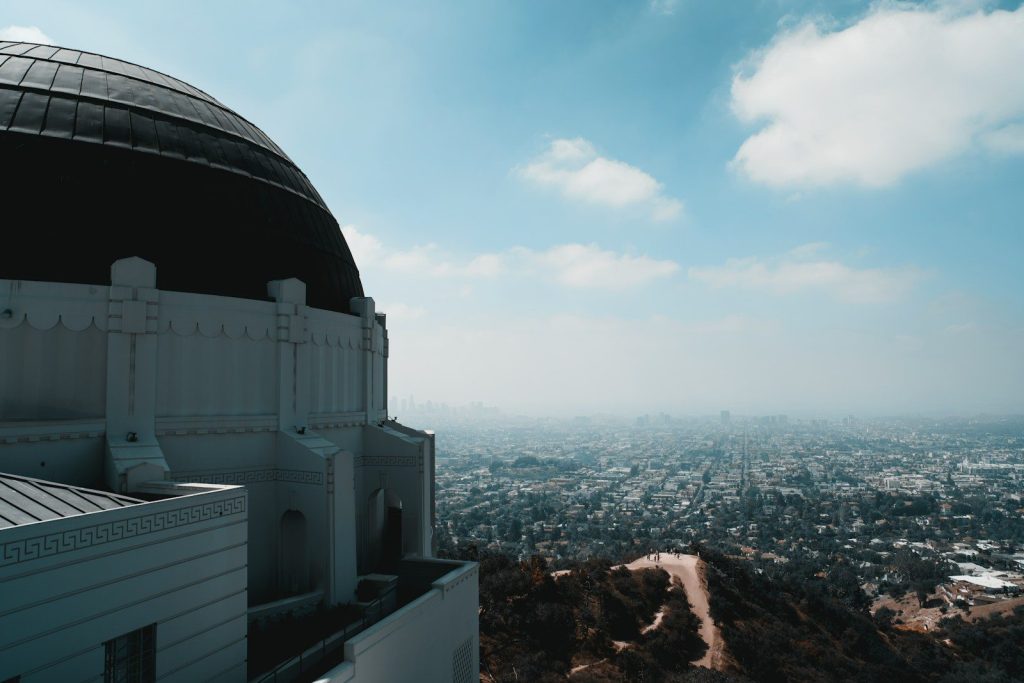Griffith observatory dome overlooking a vast city landscape.