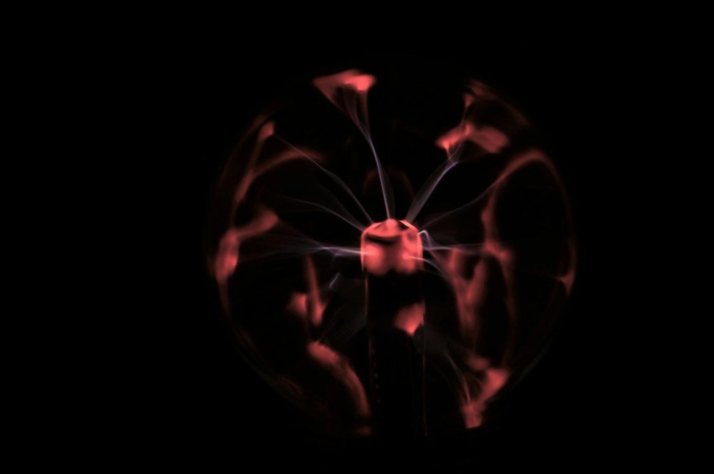 a black background with a red circular object in the middle