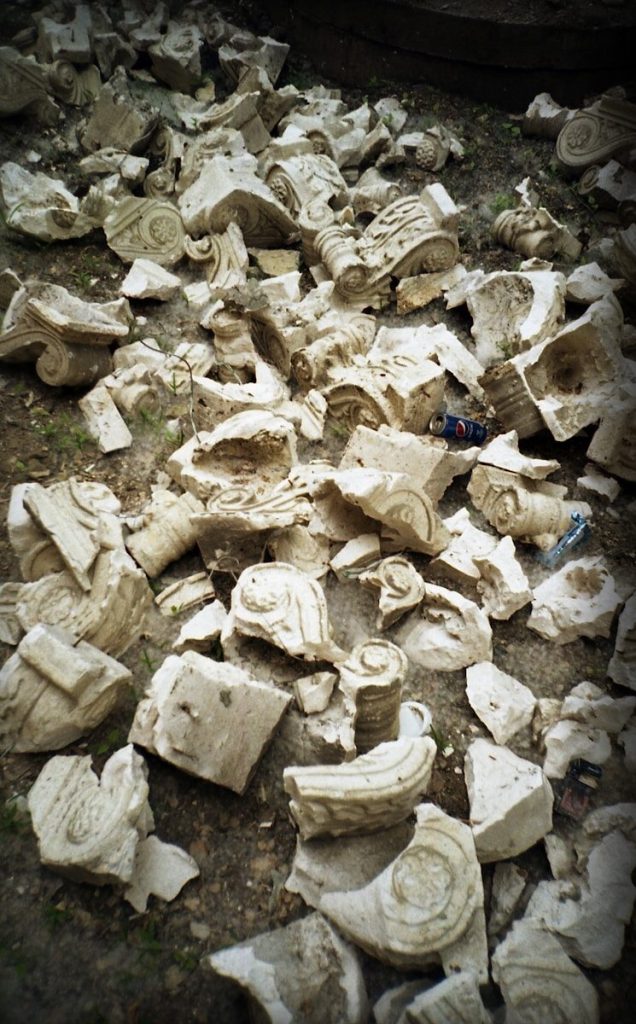 a pile of rubble sitting on top of a dirt field