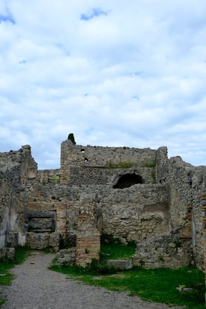 Ancient stone ruins under a cloudy sky.