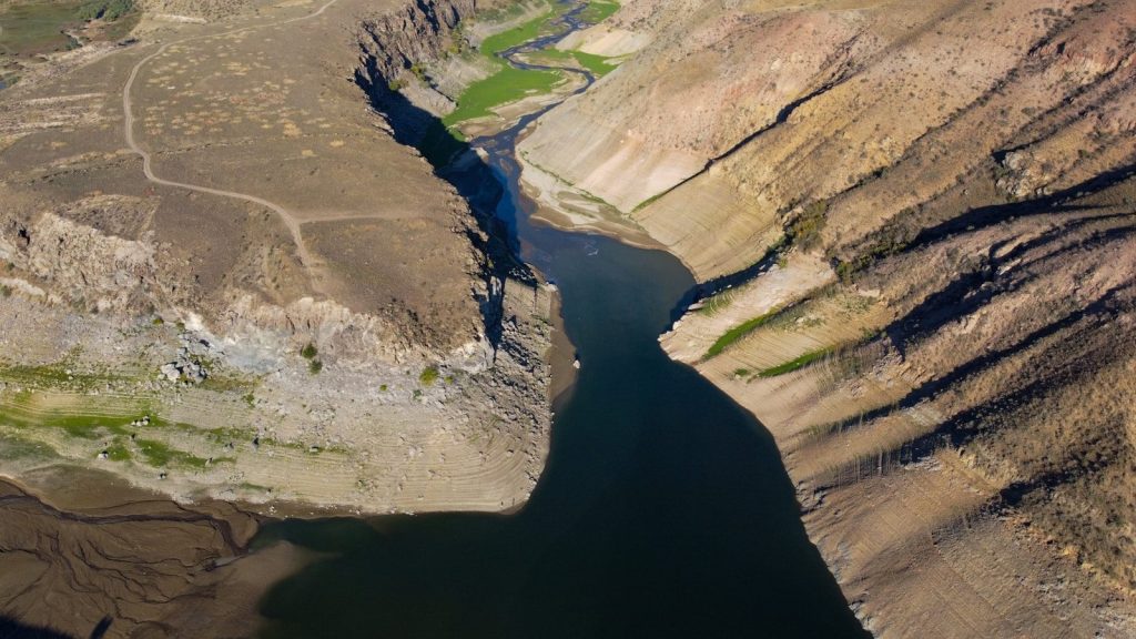Aerial view of a river cutting through dry, rocky canyons.
