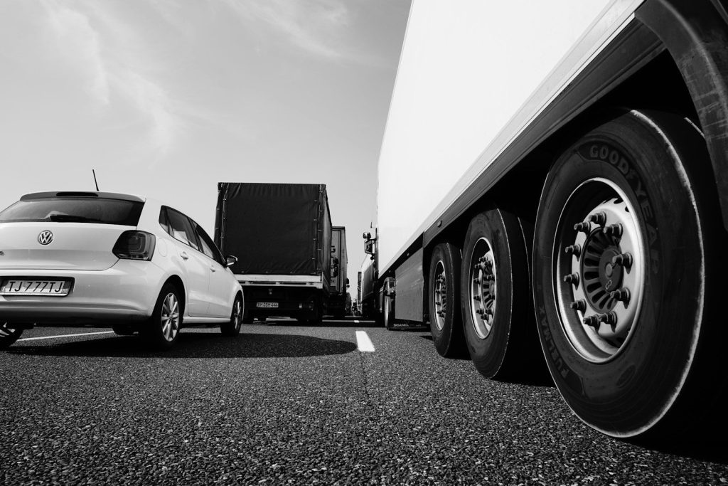 white coupe parked beside white truck
