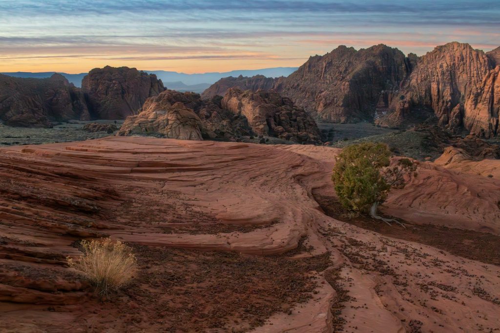 Red rock formations and desert landscape at sunrise