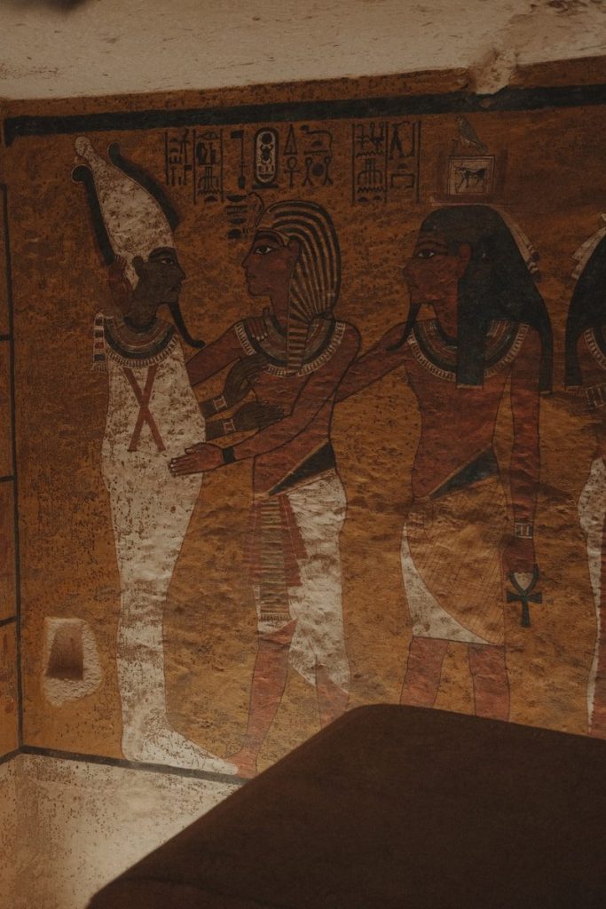 Ancient egyptian hieroglyphs and figures on tomb wall.