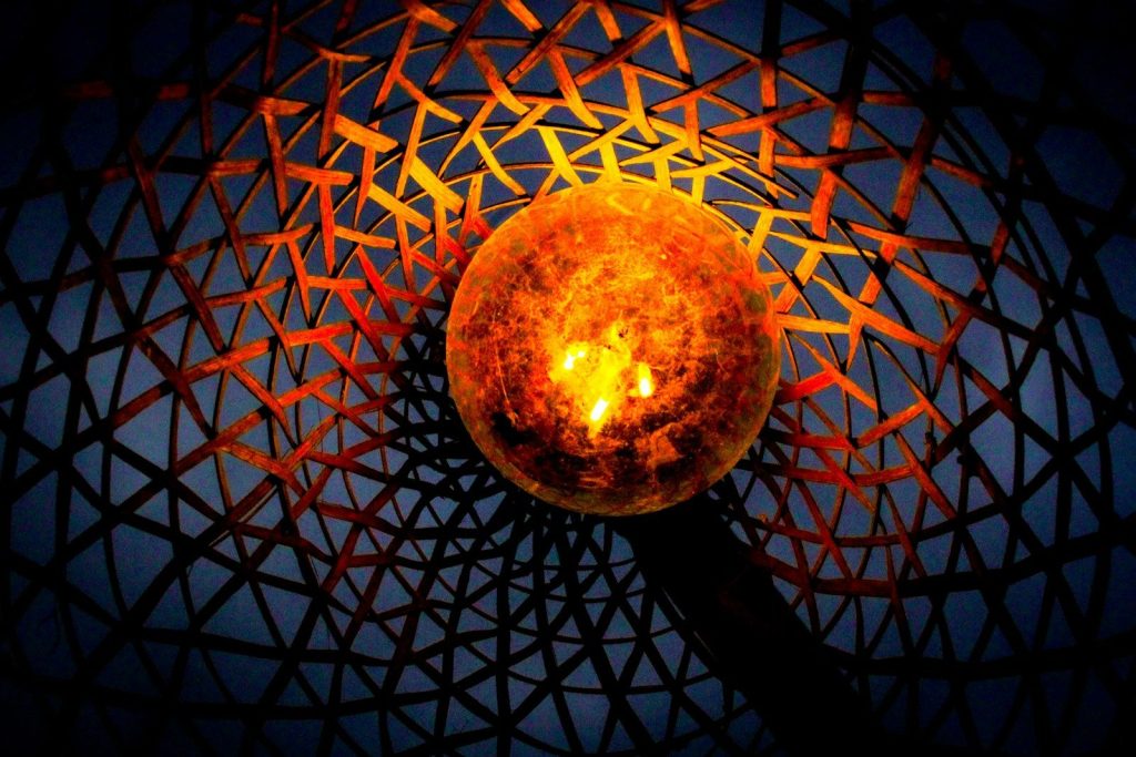 A candle is lit inside of a structure