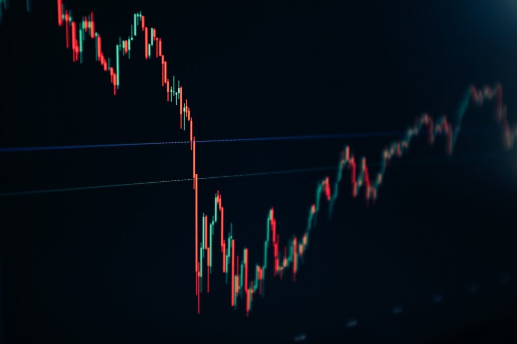 candlestick stock chart on dark screen