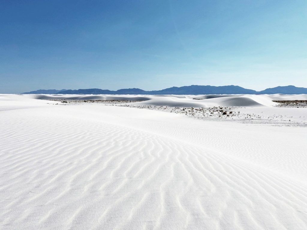 white sand under blue sky during daytime
