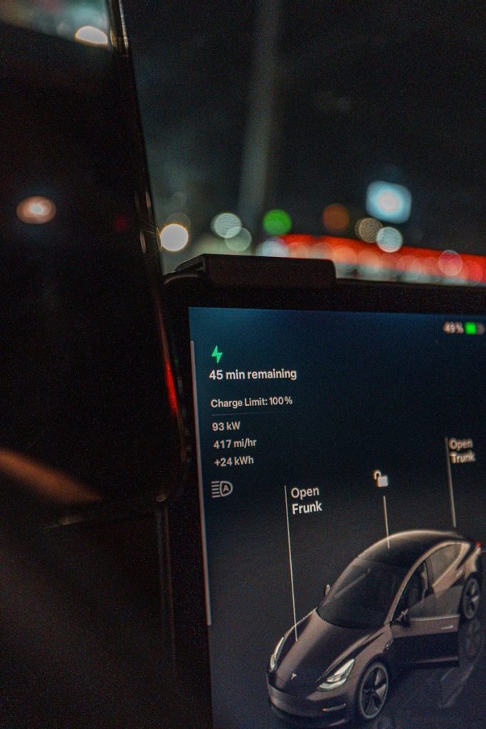 Tesla charging and showing remaining time and stats.