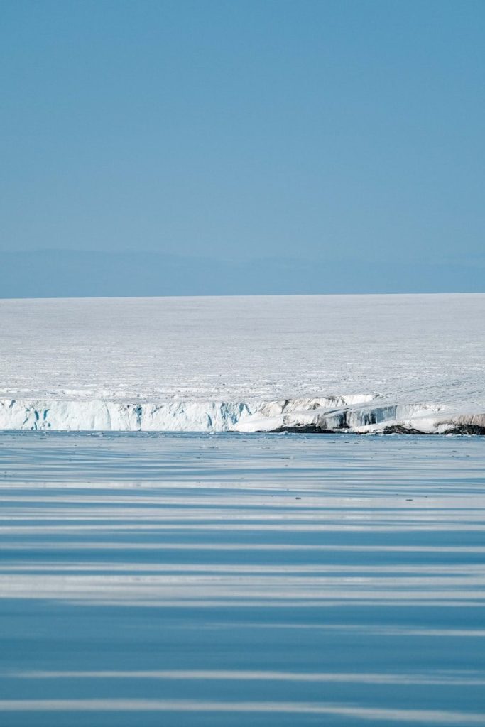 A large iceberg floating on top of a body of water