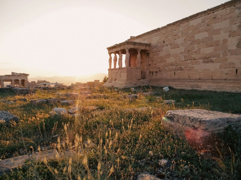Ancient ruins bathed in warm, soft sunset light.