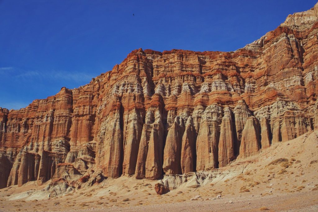 A rocky mountain with a blue sky in the background