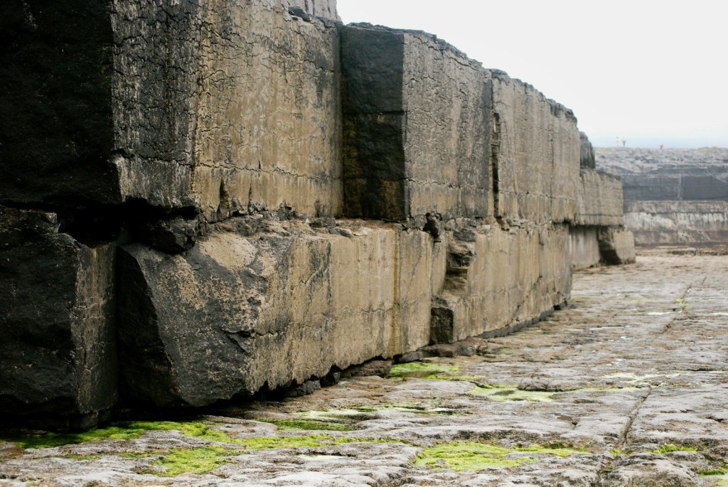a stone wall with moss growing on it