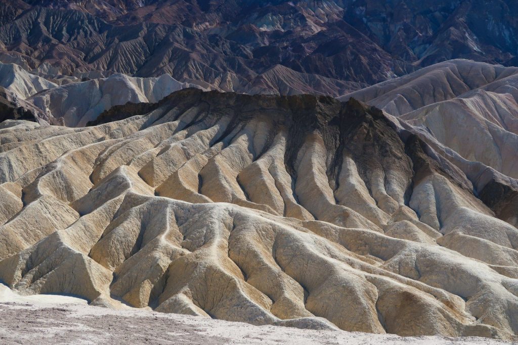 Barren desert badlands with layered rock formations