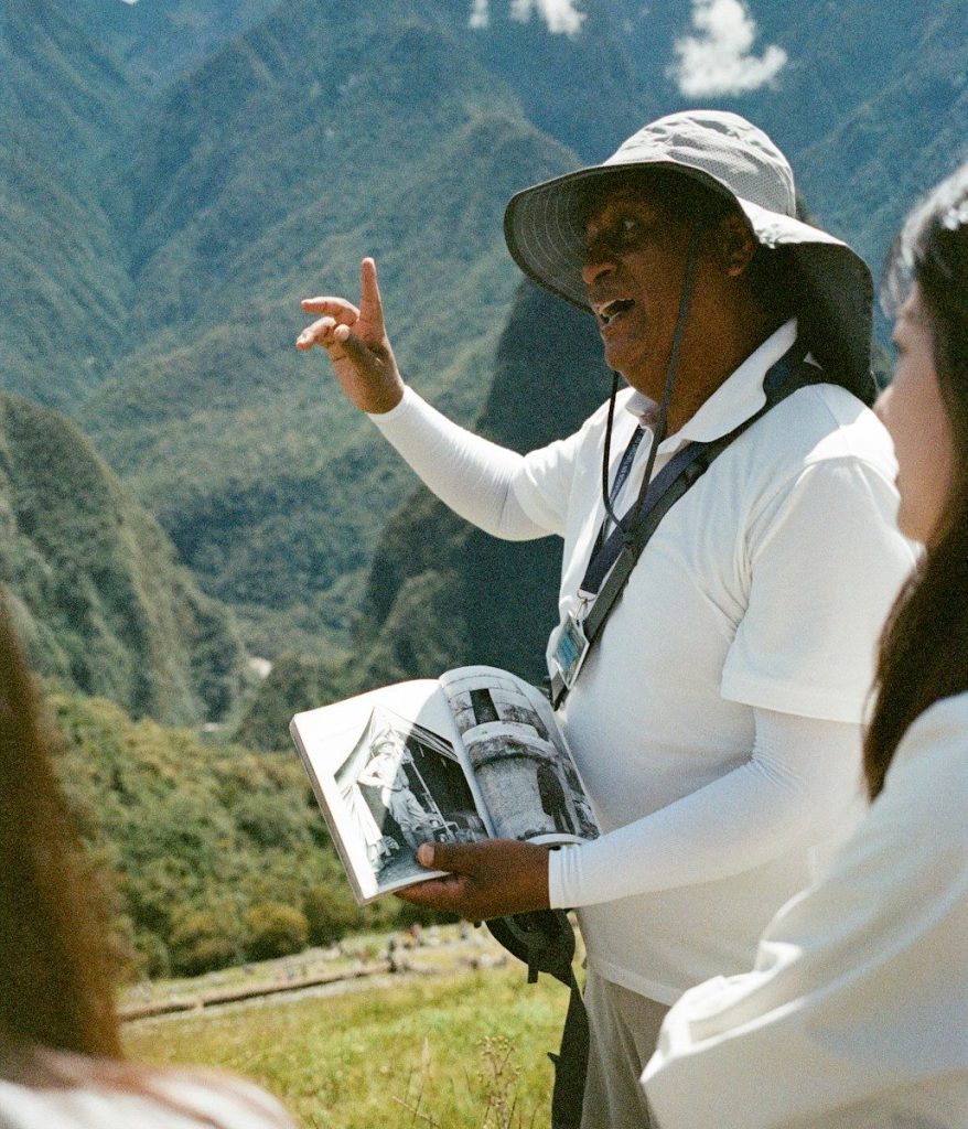 Tour guide explaining history with a book.