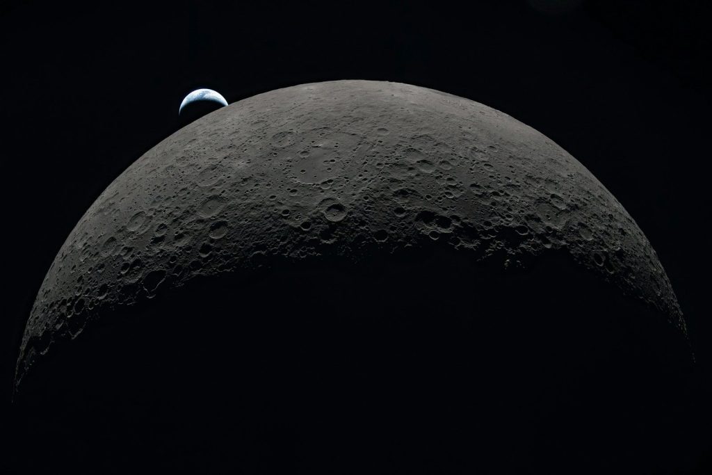 Earth rising over the moon's horizon