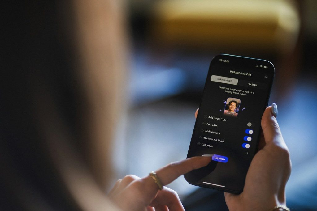 Person using a smartphone with a profile on screen.