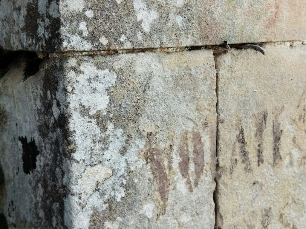 A close up of a stone block with writing on it