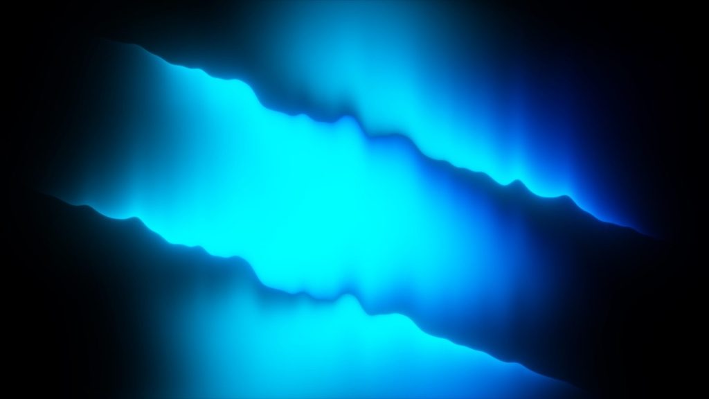 Abstract glowing blue and cyan light on a dark background.