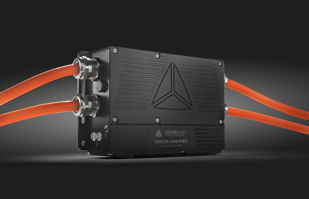 a black box with orange wires attached to it