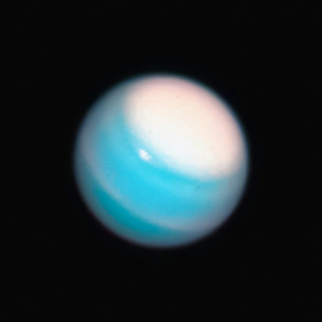 a blue and white object in the dark sky