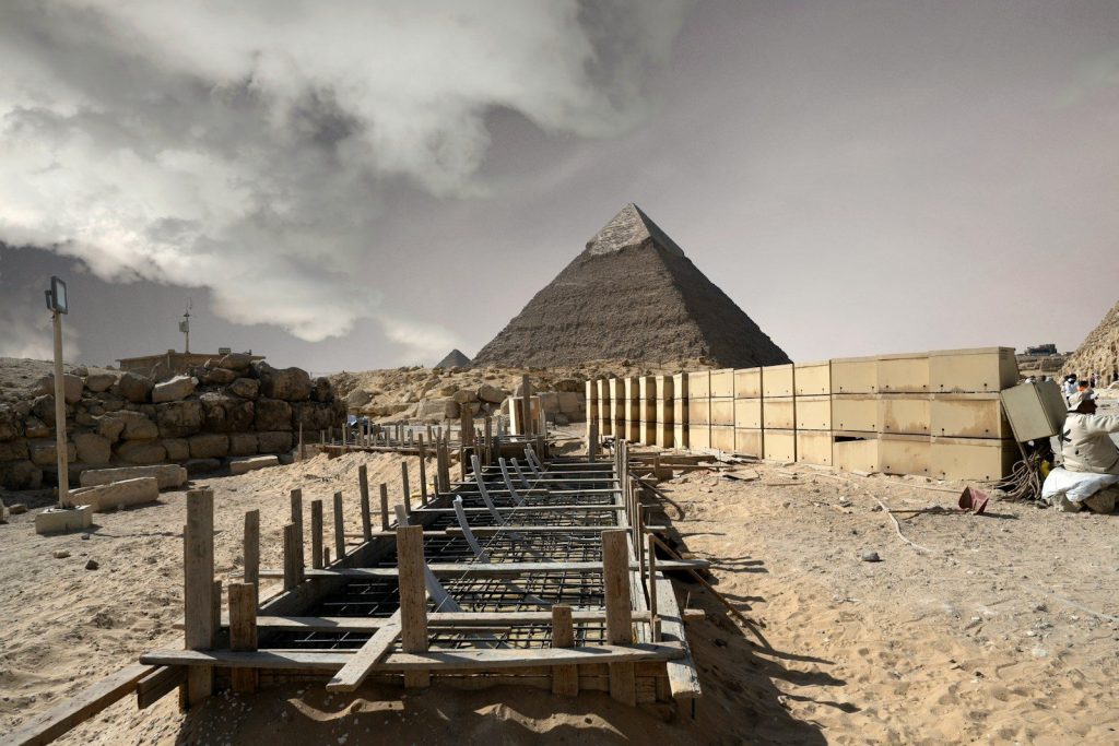 Ancient egyptian pyramid under a cloudy sky.