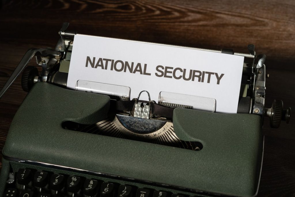 Close-up of a vintage typewriter with a paper showing the words 'National Security.'