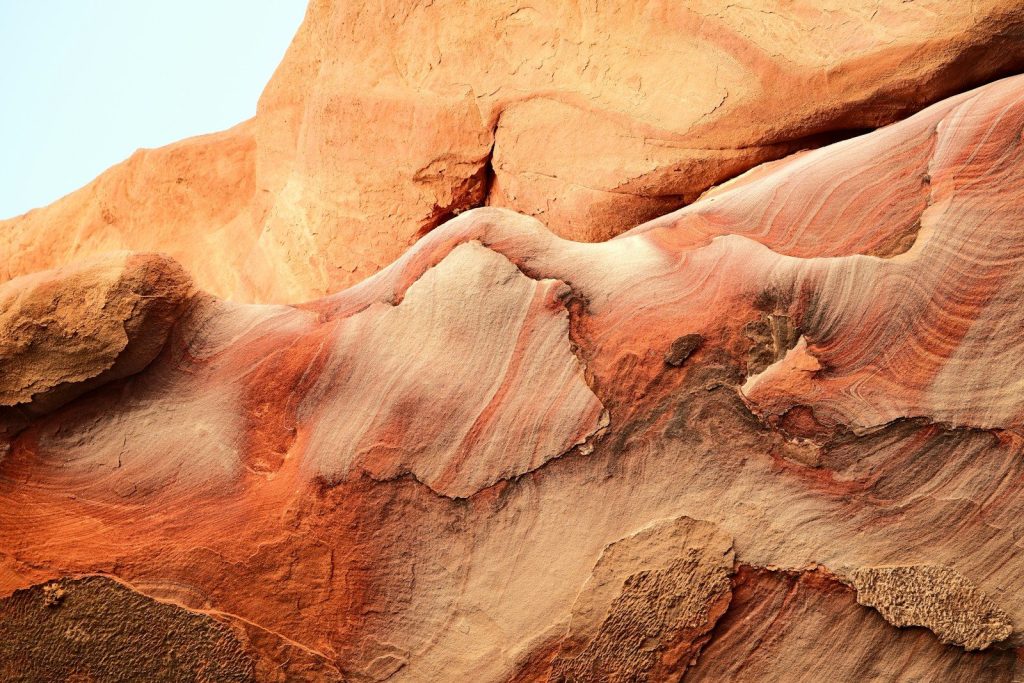 Close-up of colorful sandstone rock formations with swirling patterns