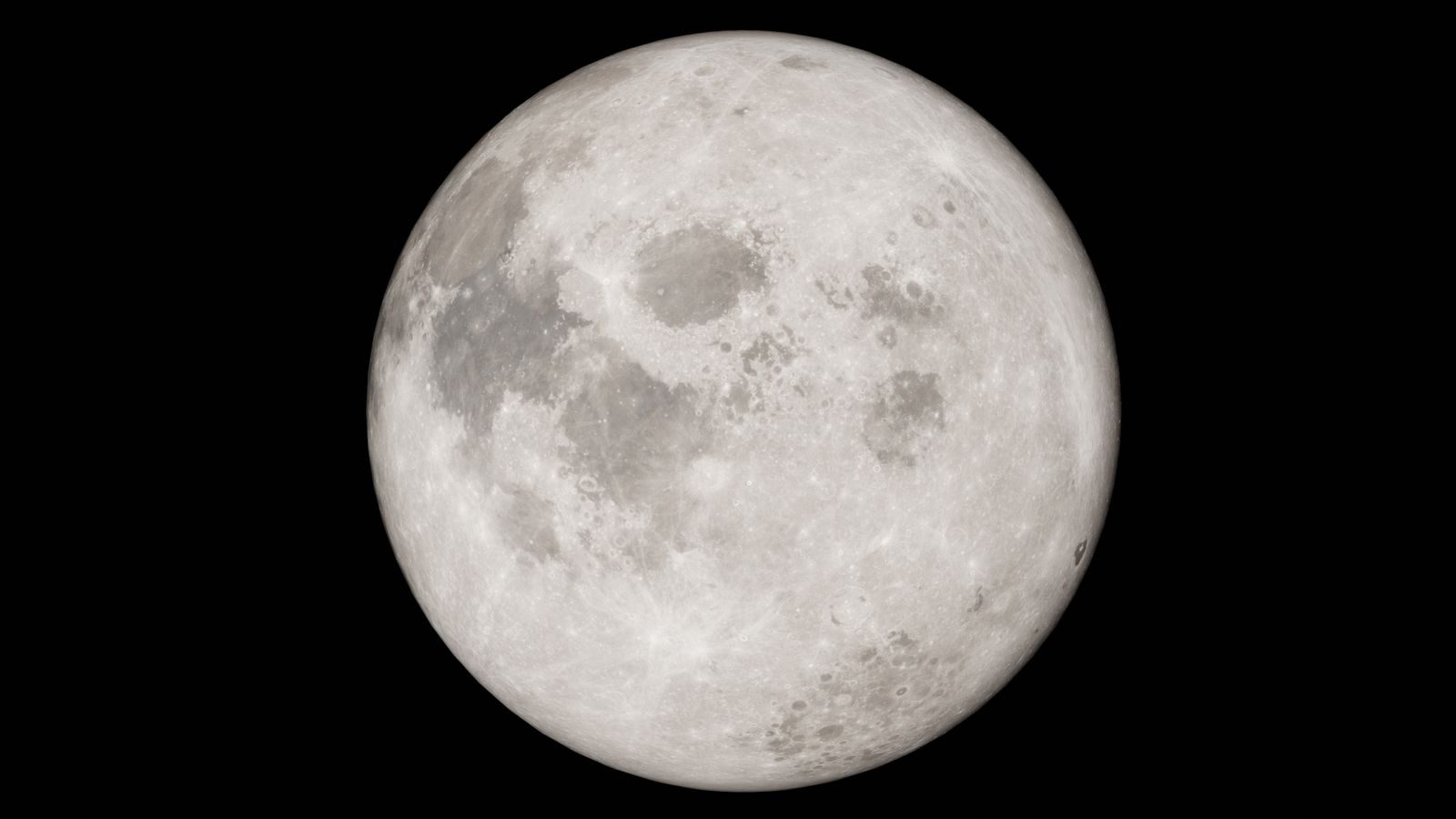 Detailed image of a full moon against a black night sky, showcasing lunar features.