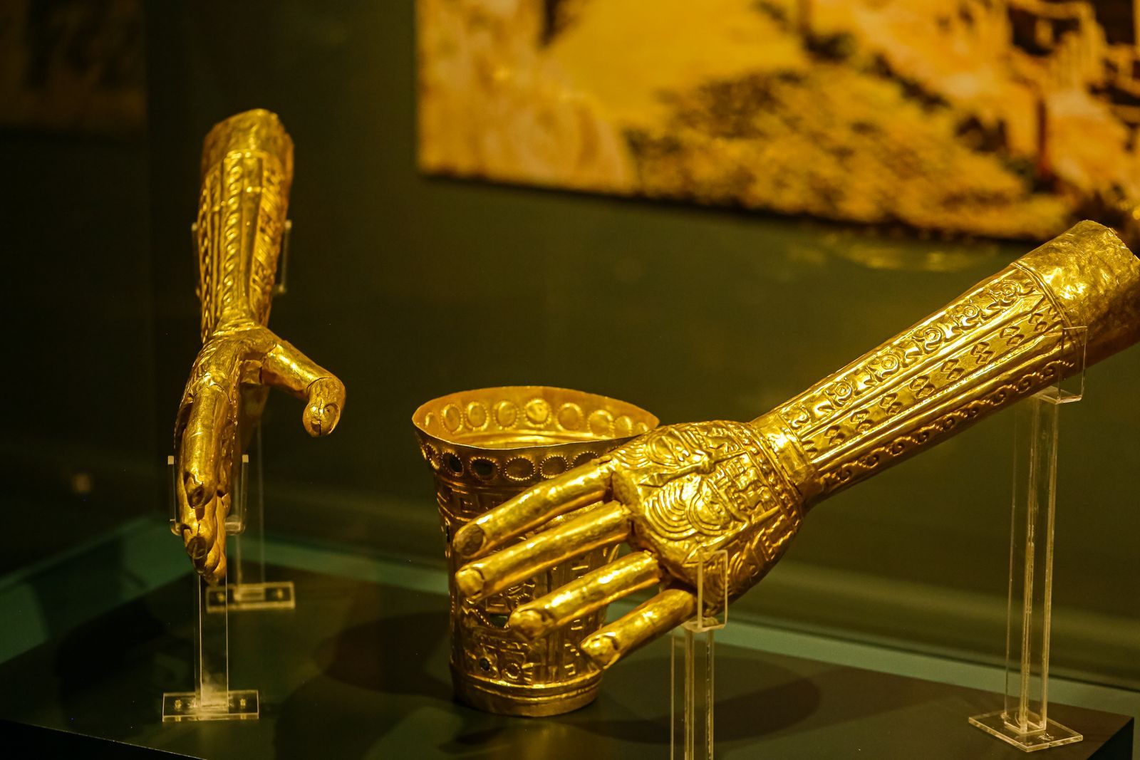 Exquisite ancient golden artifacts displayed in a museum exhibit showcasing intricate craftsmanship.