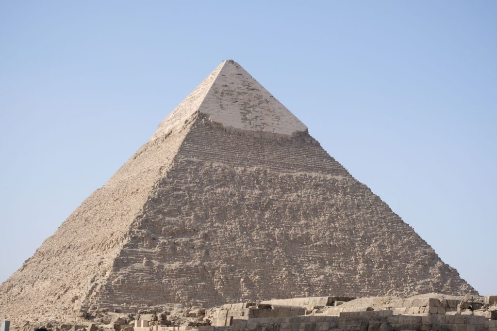 Iconic Great Pyramid of Giza, a marvel of ancient architecture under a clear blue sky.