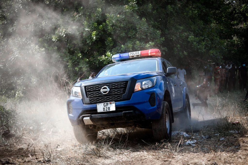 A police vehicle navigates offroad terrain in Kintampo, Ghana, showcasing law enforcement readiness.