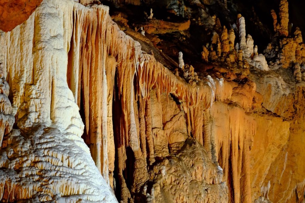 Detailed view of stalactites and stalagmites, showcasing natural cave formations.
