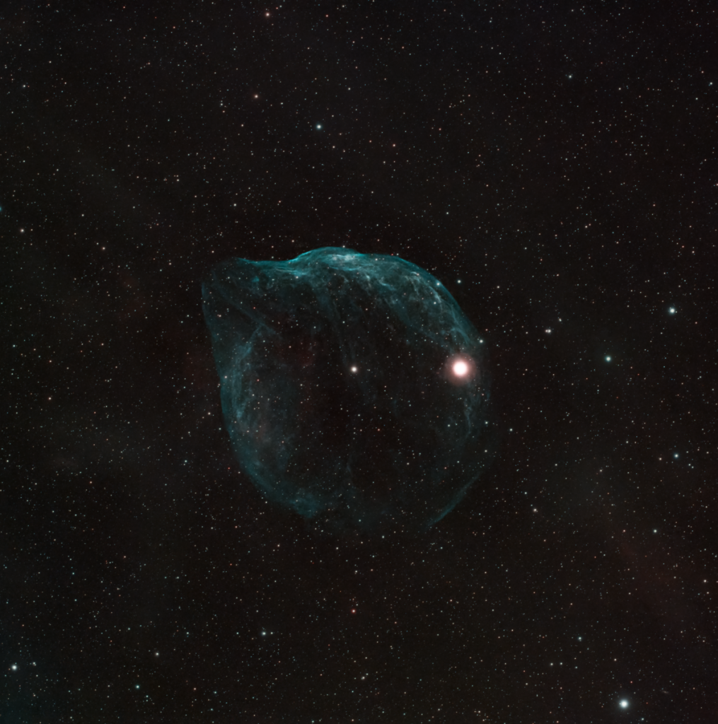 Breathtaking view of a starry sky with a prominent blue nebula. Perfect for astronomy enthusiasts.
