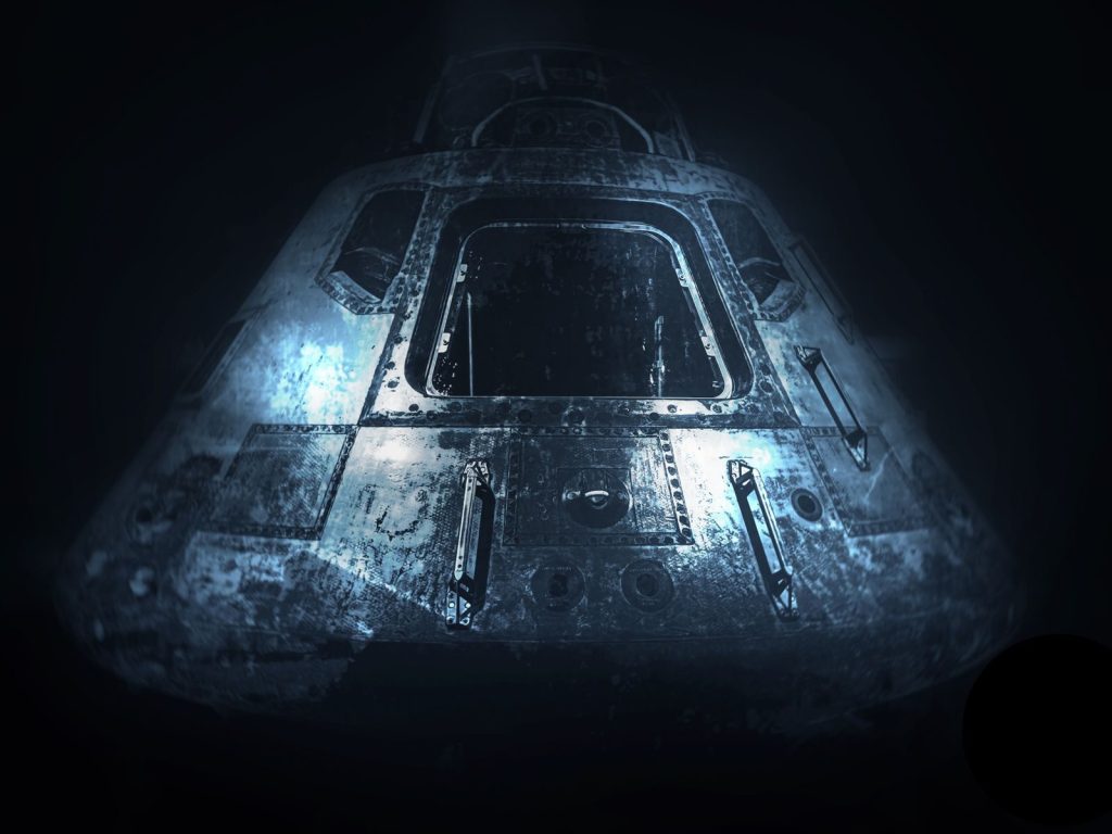 A dramatic monochrome image of an old space capsule in dim light, showcasing space exploration history.