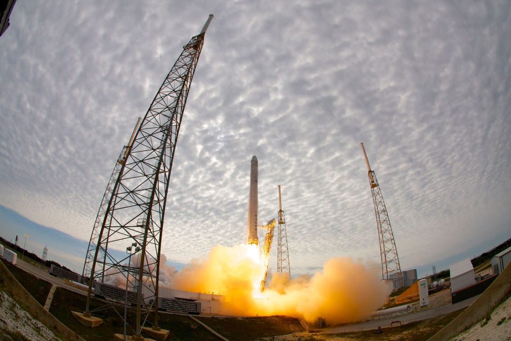 Wide angle of space station during liftoff of rocket after countdown against cloudy sky