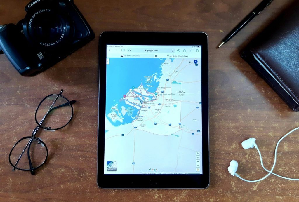 black ipad on brown wooden table