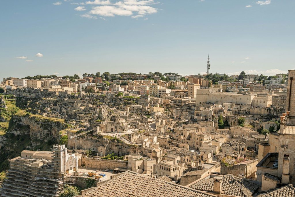 Ancient city built into a hillside under a clear sky.