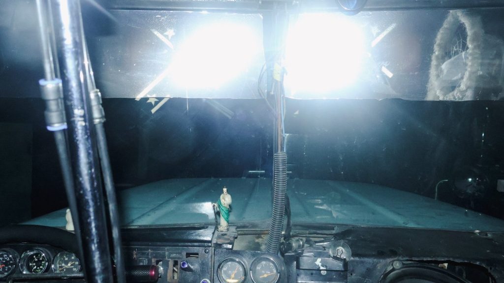 Dashboard view of bright lights on a dark road.