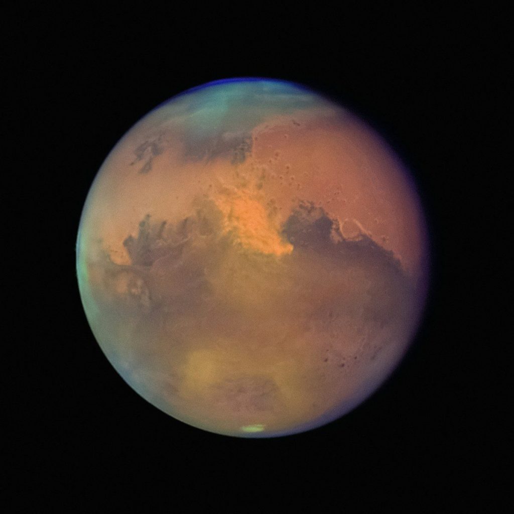 a red and blue planet with a black background