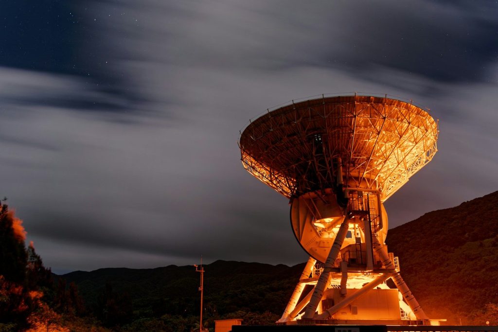 A large satellite dish sitting on top of a hill