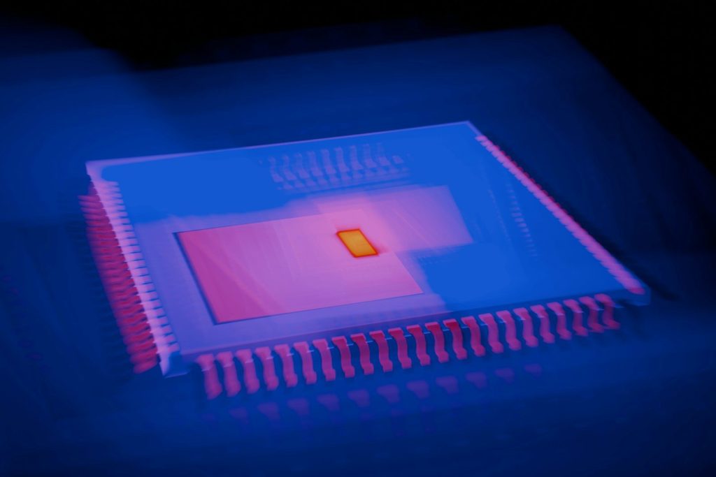 A close up of a computer chip in a dark room