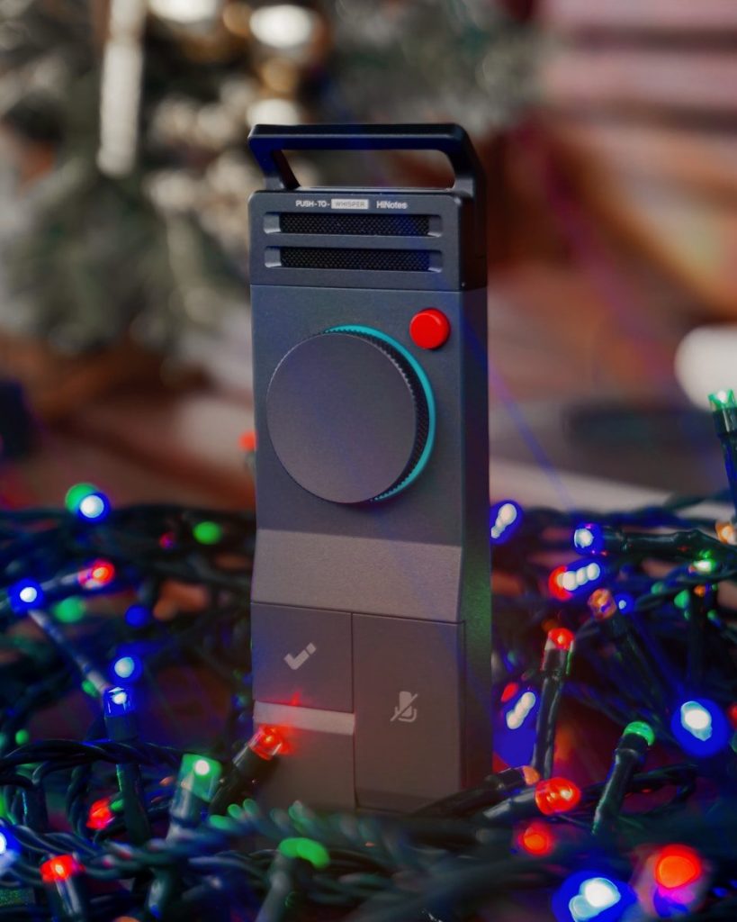A tall, dark gray electronic device with a red button.