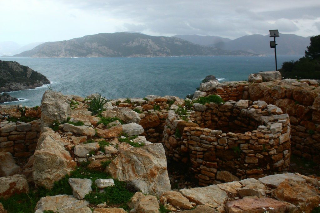 Ancient stone ruins overlooking a blue sea